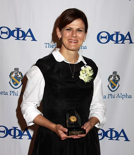 woman holding siena medal 2016